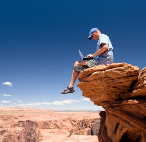 Working from a laptop on a rock